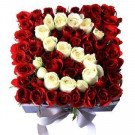 Red and white roses arranged in square box forming letter S shape