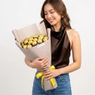 Gold-wrapped chocolate bouquet with cream tissue paper and yellow ribbon accent