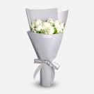 White roses bouquet with baby's breath, wrapped in lavender paper with ribbon bow