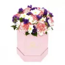Pink hexagonal box with purple, pink, and white mixed flowers arrangement