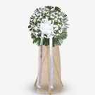 White roses and baby's breath with green foliage on beige standing easel