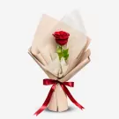 Single red Ecuadorian rose wrapped in cream paper with burgundy ribbon bow