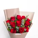 Red roses bouquet with eucalyptus greenery wrapped in beige paper
