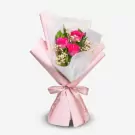 Pink roses bouquet with white filler flowers wrapped in pink and white paper