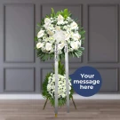 White anthurium and daisy standing funeral spray arrangement with green foliage