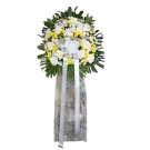 Funeral standing spray with white roses, yellow chrysanthemums, and green foliage