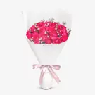 Pink roses bouquet with white baby's breath in white wrapping and pink ribbon