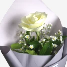 White rose with white and yellow daisies wrapped in gray paper bouquet