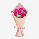 Pink wrapped bouquet with vibrant magenta roses and white filler flowers