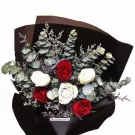 Luxury bouquet with red and white roses, eucalyptus, wrapped in black paper