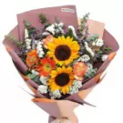 Vibrant bouquet featuring yellow sunflowers, orange roses, white filler flowers wrapped in mauve paper