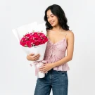 Vibrant pink roses with white baby's breath flowers in elegant white box arrangement
