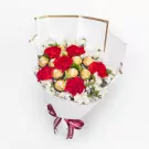Red carnations with gold chocolates and white baby's breath in white wrap