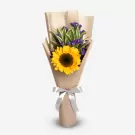 Sunflower bouquet with purple statice in kraft paper wrapping and ribbon bow
