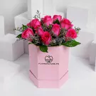 Pink box with twelve hot pink roses and green foliage arrangement