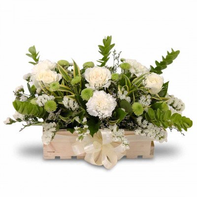 Our Touch of Heaven arrangement features 3 white roses, 3 white carnations, 4 stems of green mums, white statice, korea leaves, eucalyptus leaves, and aster.