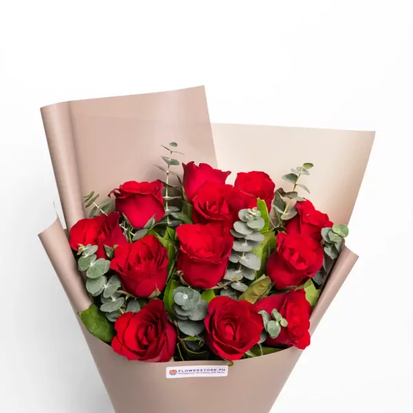 Red roses bouquet with eucalyptus greenery wrapped in beige paper