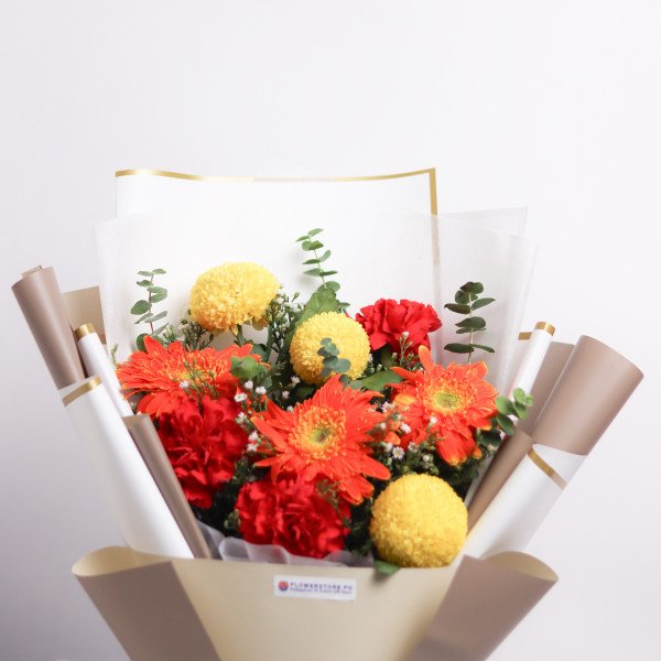Orange Blossom consists of yellow pingpong, red carnation, orange gerbera, aster, and eucalyptus.