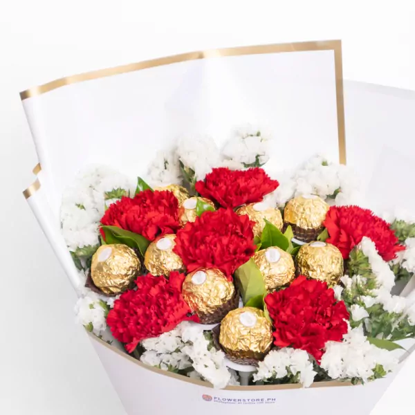 Red carnations with white chrysanthemums and gold chocolate candies in white wrapping