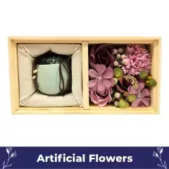 Gift set containing cream ceramic mug and pink artificial flowers in wooden box