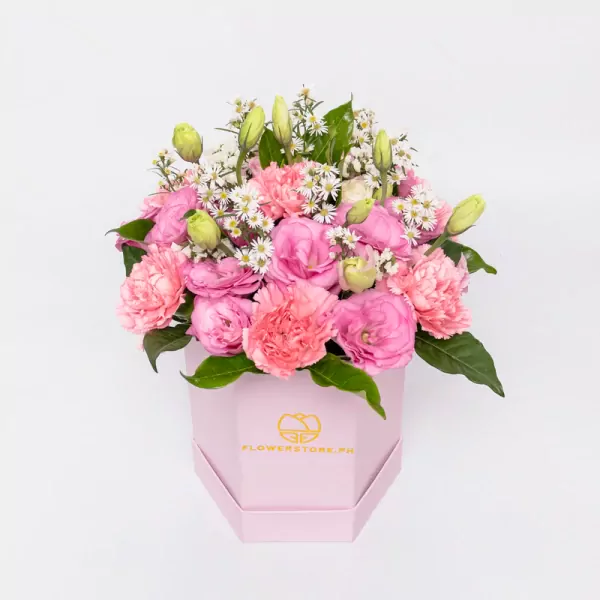Pink carnations and white daisies in a luxe hexagonal pink gift box