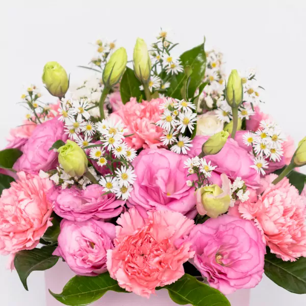 Pink peonies and roses with white daisies and green buds in lush arrangement