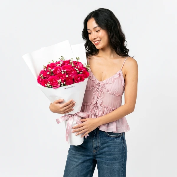 Vibrant pink roses with white baby's breath flowers in elegant white box arrangement