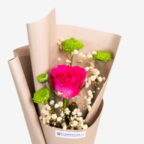 Vibrant pink rose bouquet with green chrysanthemums and white baby's breath in kraft paper wrapping