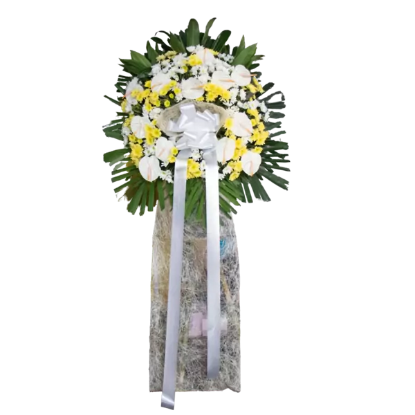Funeral standing spray with white roses, yellow chrysanthemums, and green foliage