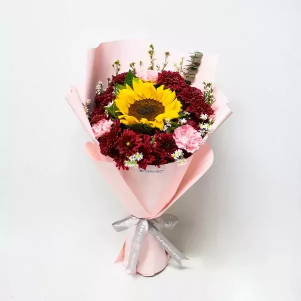 Sunset Elegance features a sunflower, purple carnations, and magna red mums!
