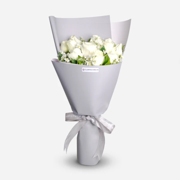 White roses bouquet with baby's breath, wrapped in lavender paper with ribbon bow