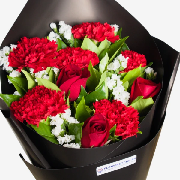 Red carnations and roses with white baby's breath in black wrapper bouquet