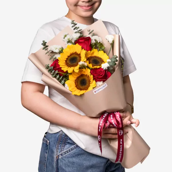 Sunflower bouquet with red roses, white flowers, and eucalyptus in beige wrapping