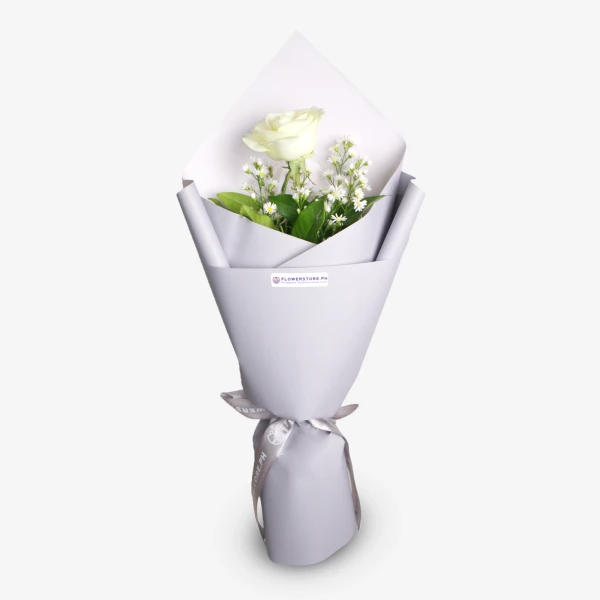White rose bouquet with baby's breath and greenery wrapped in lavender paper