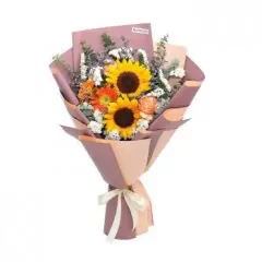 Sunflower bouquet with yellow blooms, orange accents, and pink wrapping paper