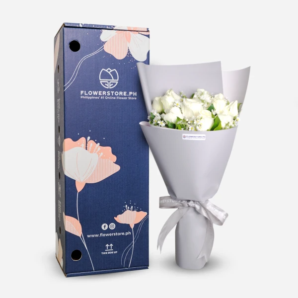 White roses bouquet with baby's breath wrapped in gray paper with ribbon bow