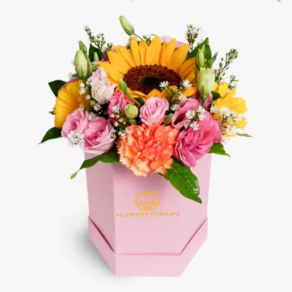 Vibrant pink hexagonal box with yellow sunflowers, pink roses, and coral carnations