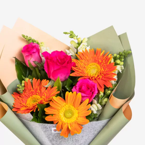 Vibrant bouquet with orange gerberas, pink roses, and white filler flowers in green wrapping