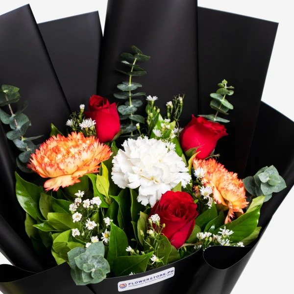 Elegant black-wrapped bouquet featuring red roses, orange proteas, white carnations, and greenery
