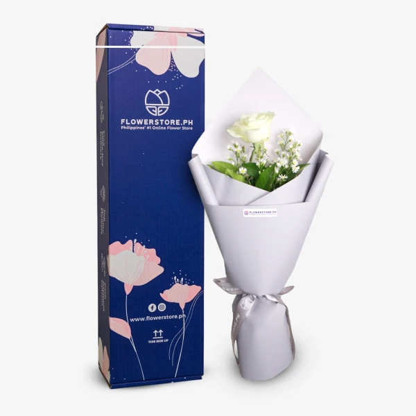 White roses bouquet with green foliage in white wrapping and FlowerStore.ph packaging