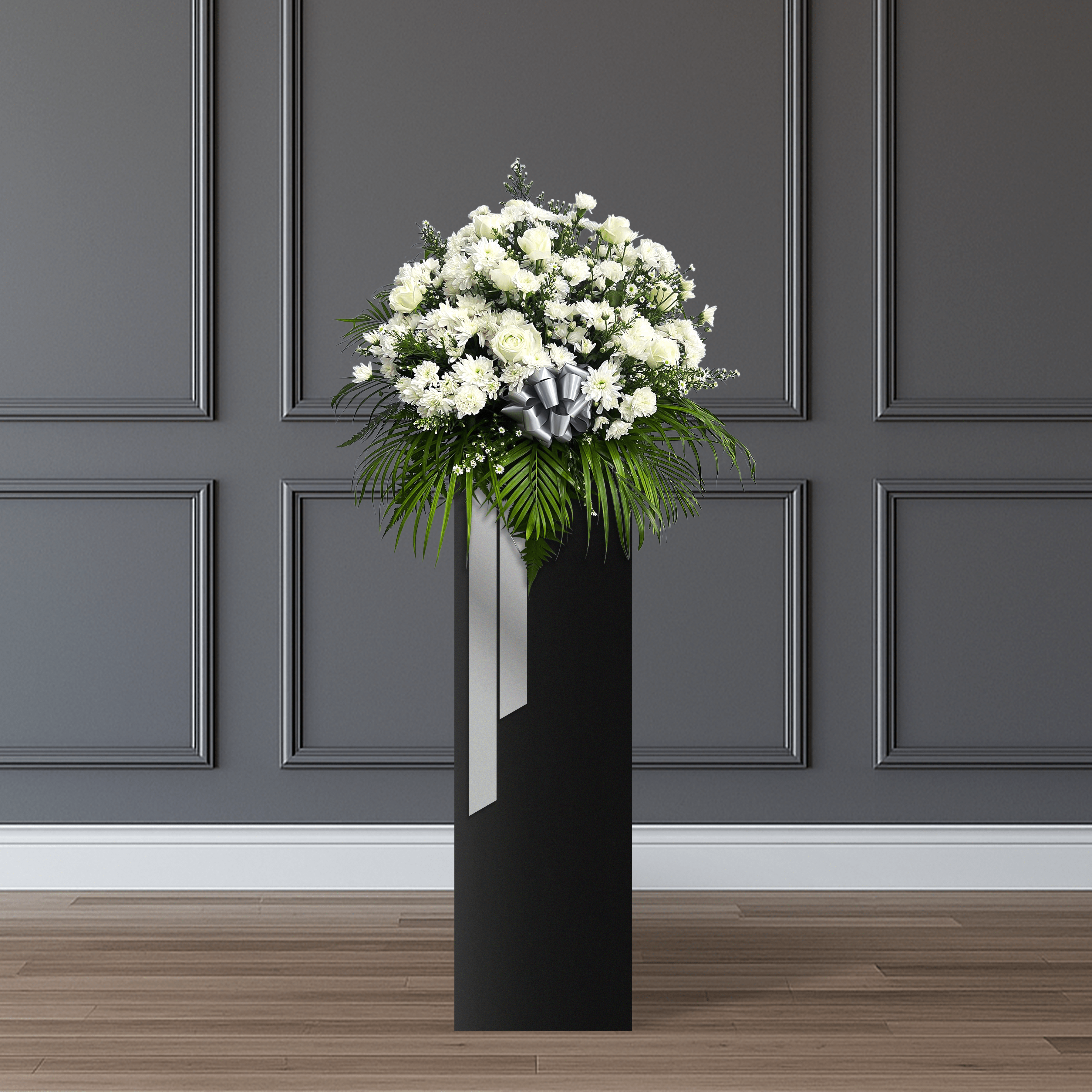 This stand consists of white roses, spray white mums, white carnations, white phoenix, and finger palm leaves.