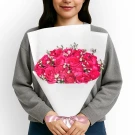 Woman holding a bouquet of vibrant pink roses and delicate white aster.