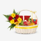 Gift basket with fruits, flowers, and tea, adorned with a yellow ribbon bow.