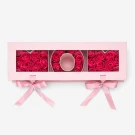 Pink box with "MOM" spelled out in pink soap roses, tied with pink ribbons.