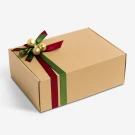 Brown gift box with red and green ribbons and gold ornaments on top.