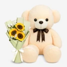 Cream teddy bear with a bouquet of sunflowers.