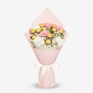 Bouquet of pink, white, and yellow carnations wrapped in pink paper with a ribbon.