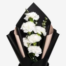 White carnation bouquet with black and tan wrapping.