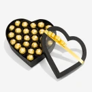 Heart-shaped box filled with golden foil-wrapped chocolates, lid open with a gold ribbon.
