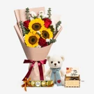 Bouquet of sunflowers and roses with a teddy bear, chocolates, and music box.